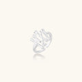 Sculptural sterling silver ring with organic branch design and textured surfaces on cream background